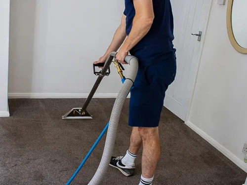 man using a carpet cleaning machine.